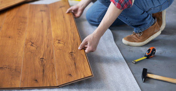 Man installing laminate flooring