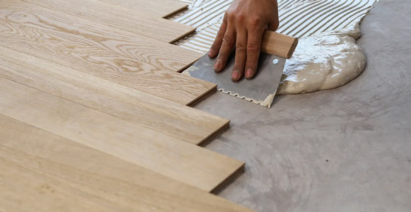 Man installing timber flooring