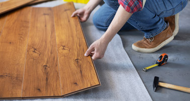 Man worker installing laminate flooring