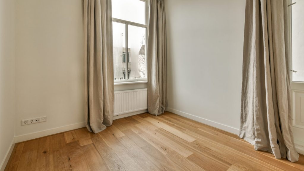 Living room with hardwood timber flooring and two windows