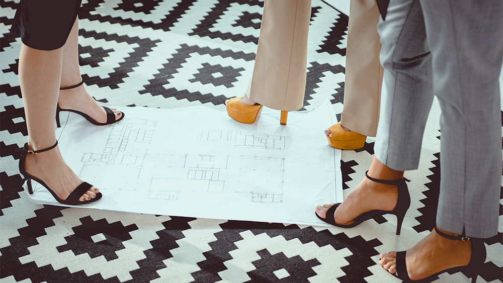 Women on high heels shoes standing on smart carpet