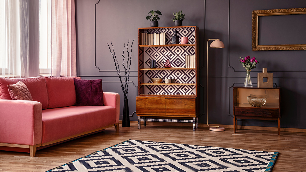 Retro wooden cupboard with books and decorations with rug