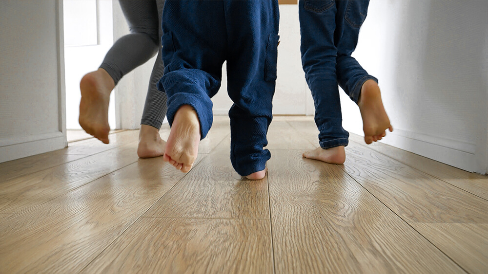 A family running on the laminated floor