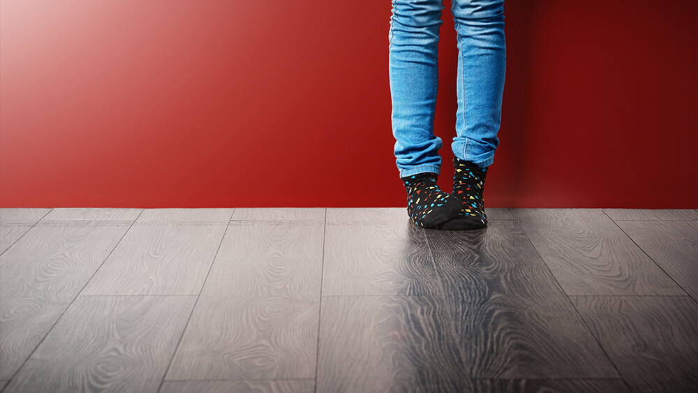 Someone with cozy socks standing on laminate flooring