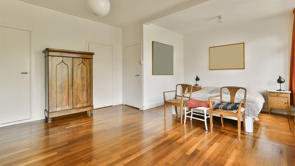 A big bedroom with timber flooring