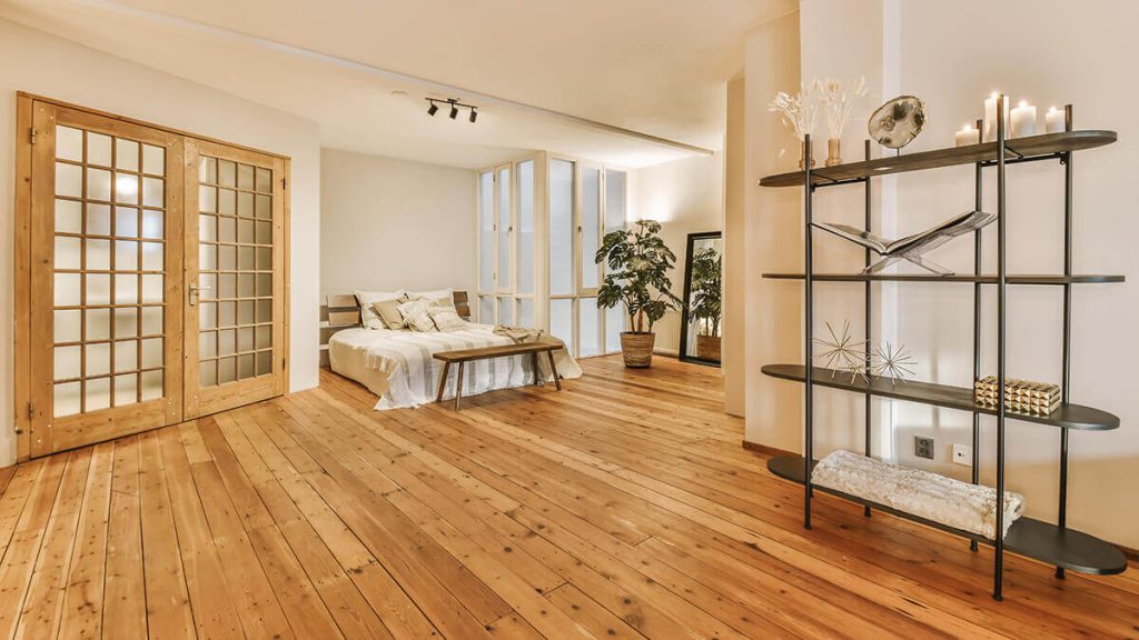 A luxurious huge bedroom with hardwood flooring