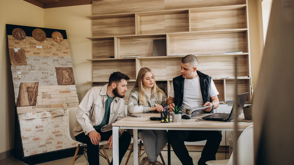 Young couple consulting with a flooring expert about the right timber finish