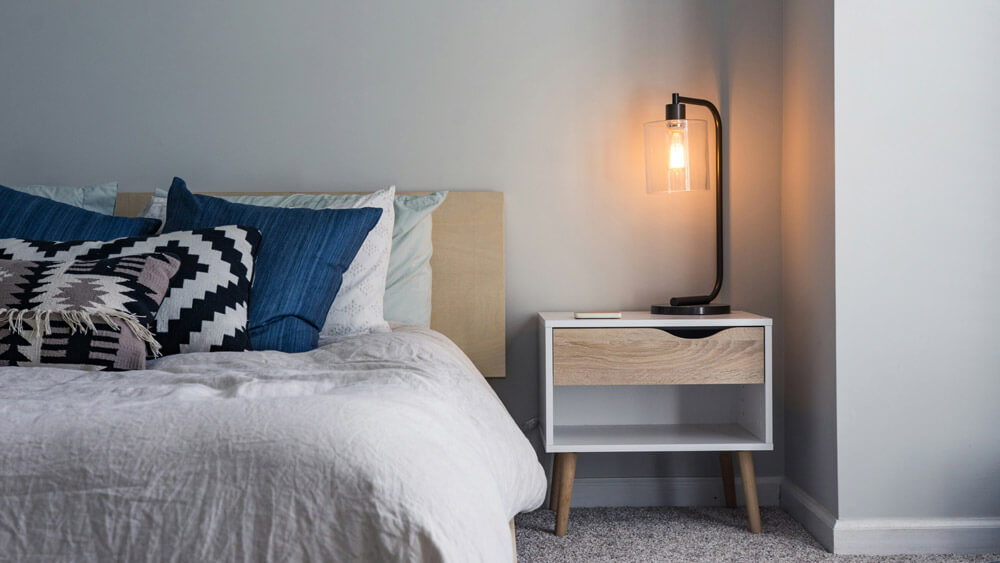 Bedroom with double bed and simple cream carpet