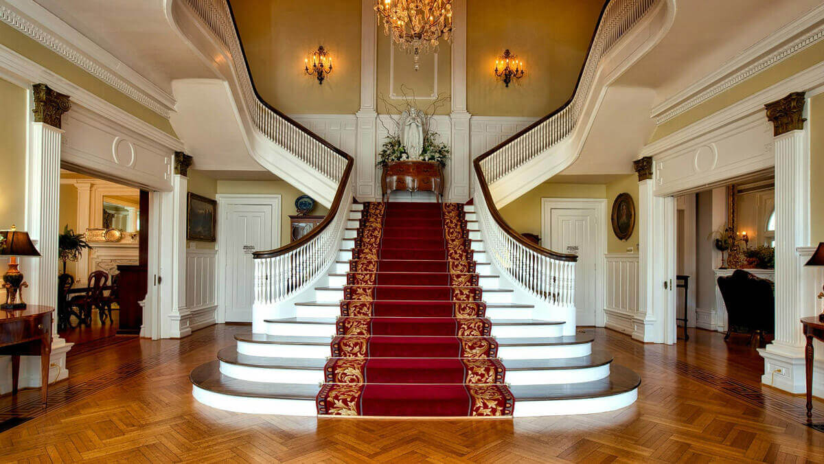 Luxurious home salon with stairs floored with red carpet