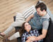 Beautiful couple on a sofa in room with laminate flooring