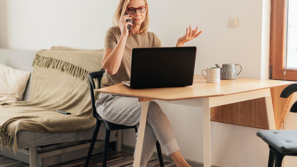 Woman working home with laptop and smartphone