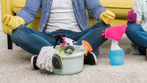 Man sitting on floor after cleaning carpet