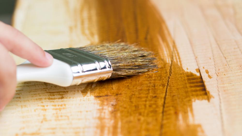 Close-up of someone staining timber floor